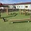 Ulkoleikkipaikka Obstacle course -esterataelementeillä, sisältää verkon ja puurakenteita.