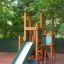 Tower with Slide lasten leikkiteline, jossa liukumäki ja puiset rakenteet.